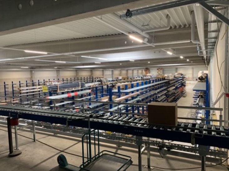 Warehouse overview with cantilever racking and conveyor line — HS-C. Hempelmann KG, Hanover